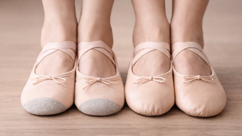 Close-up of feet wearing canvas and leather ballet shoes