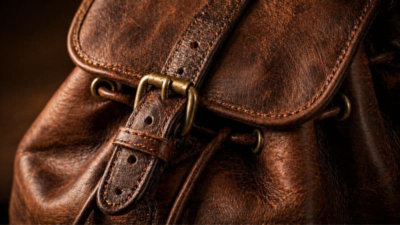 eather knapsack stitching brass hardware patina